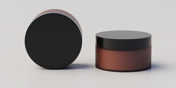 A sleek, brown container of hair putty with a black lid, demonstrating what hair putty is, and how to use hair putty, for achieving a smooth, and polished hairstyle.