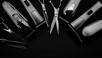 Professional black hair clipper and attachment combs on a wooden surface, showcasing hair clipper oil alternatives for efficient grooming tool maintenance