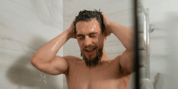 Man washing his beard in the shower – step-by-step guide on how to wash your beard and use beard wash effectively.