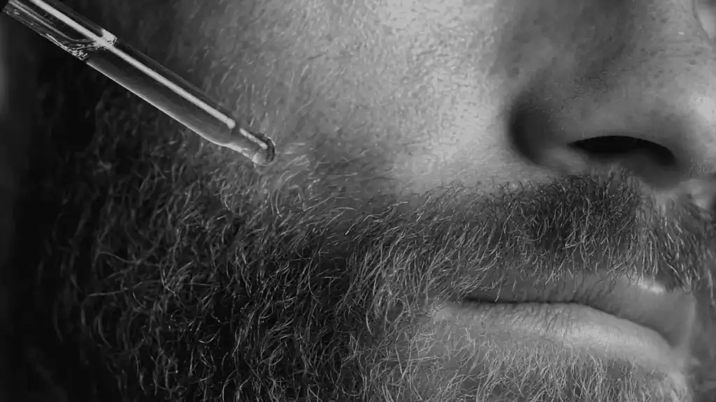 Applying Honest Amish beard oil to show texture and absorption on facial hair
