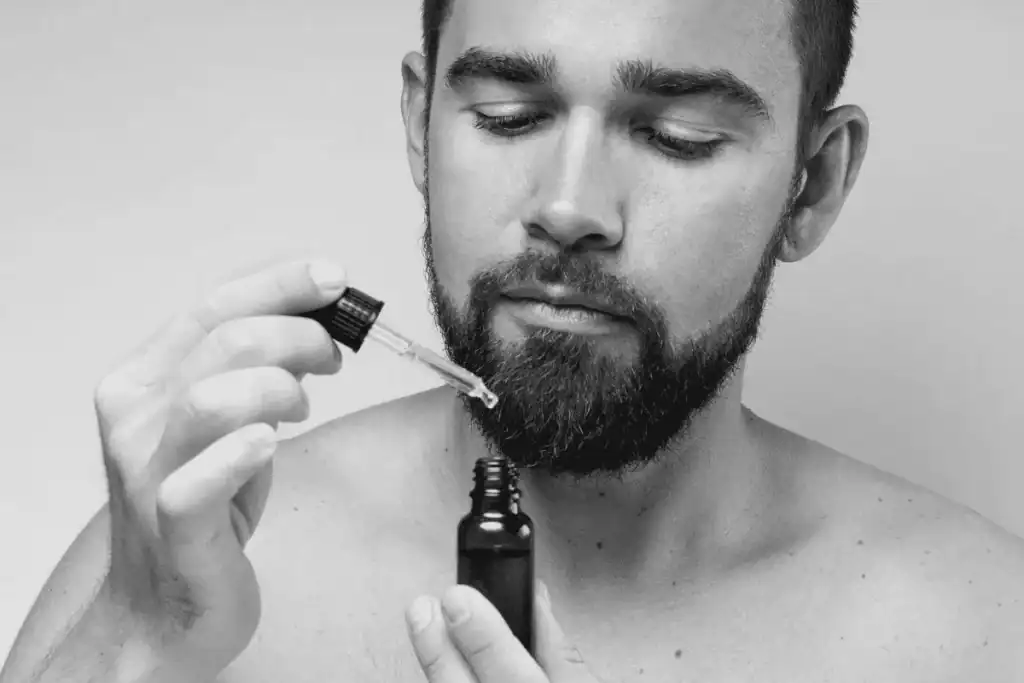 Man applying beard oil for a common beard grooming routine.