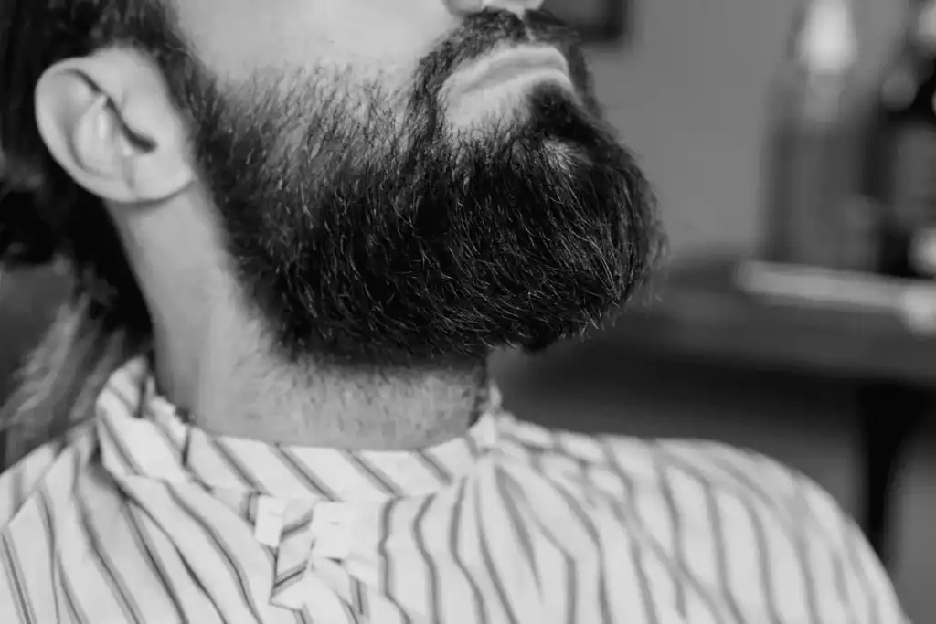 Man with a beard showing a high neckline trim mistake, one of the most common beard grooming mistakes men make.