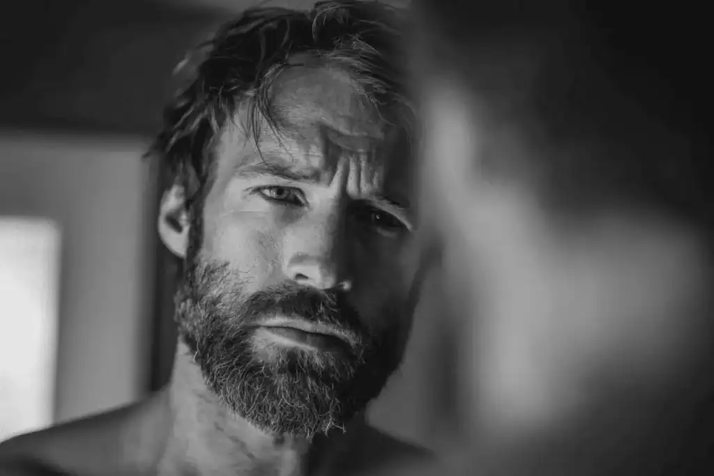 Man with patchy beard growth showing a common beard grooming mistake.