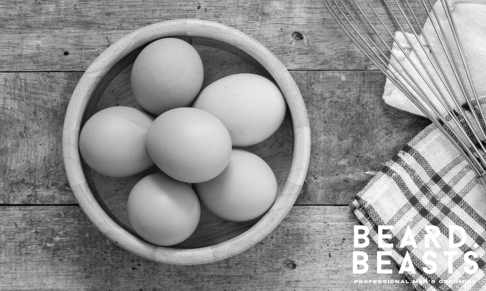 Brown eggs in a wooden bowl on a rustic kitchen table—rich in biotin and protein.