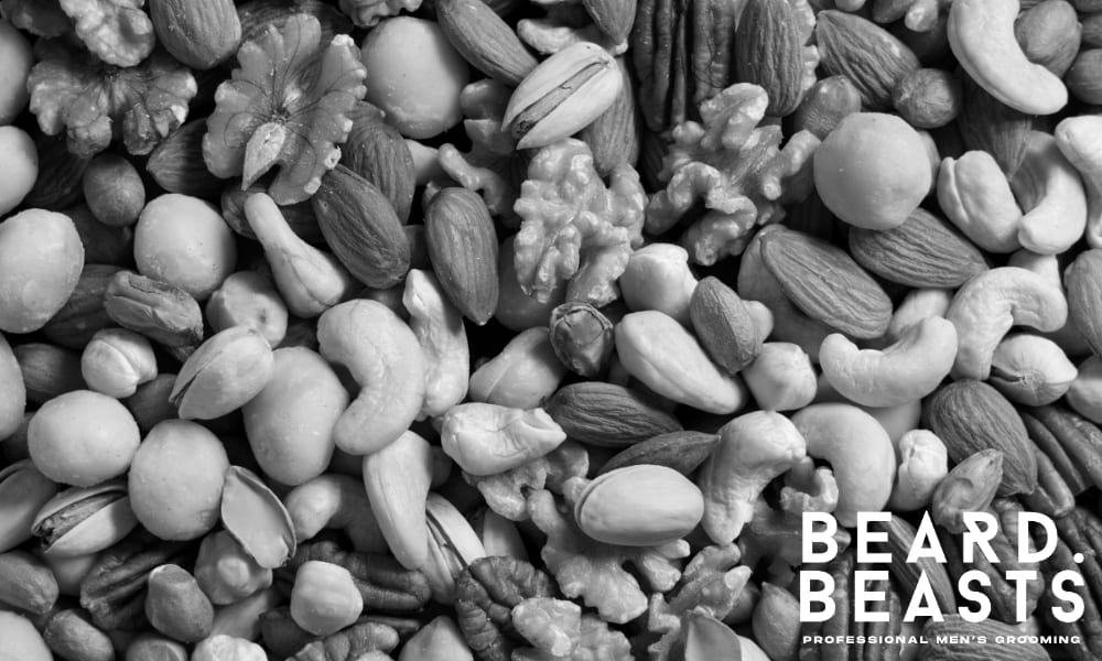 Mixed nuts including almonds, walnuts, pistachios, cashews, and macadamias—rich in zinc, vitamin E, and healthy fats for beard growth.