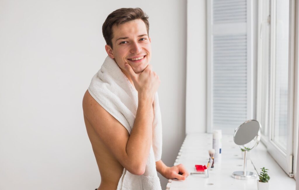A man touches his chin thoughtfully, showcasing his clean, fresh face. His expression reflects consideration of his combination skin type as part of his skincare routine. The image highlights the importance of knowing your skin type to maintain a healthy and balanced men's skincare routine.