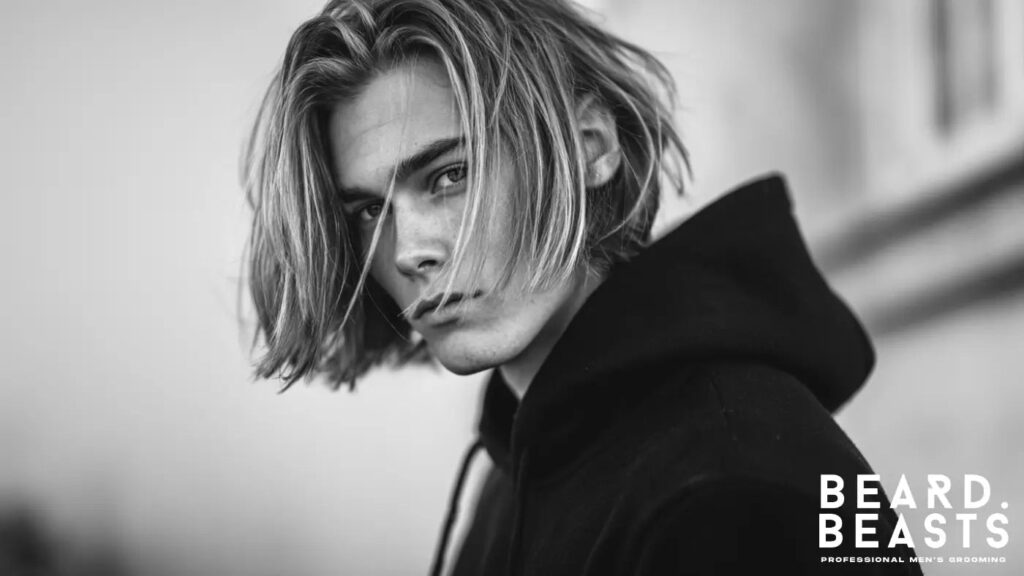 Young man with long, straight hair wearing a hoodie — showcasing a clean, defined look ideal for men's straight hair care and grooming routines.