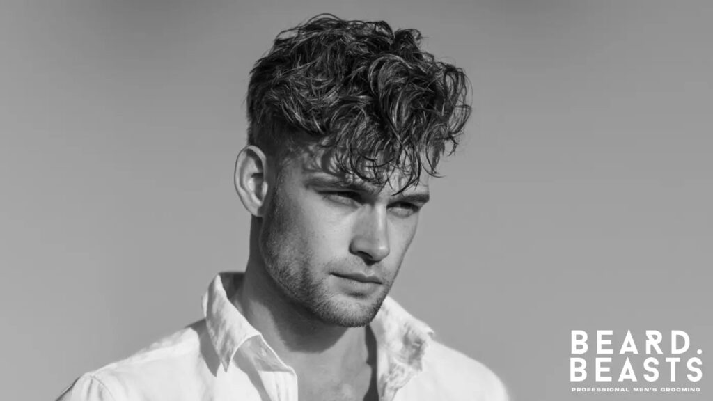 Young man with short, textured wavy hair styled naturally — ideal example of healthy waves for men’s wavy hair care and grooming routines.