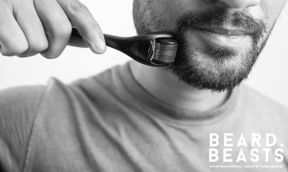 Close-up of a man using a derma roller on his beard to stimulate facial hair growth through microneedling