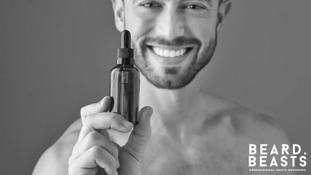 Smiling man holding a bottle of beard oil used for moisturizing and conditioning facial hair