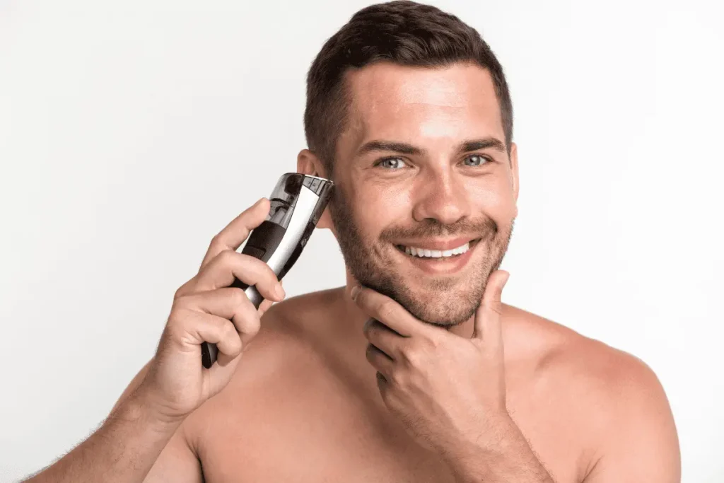 Man trimming a 2mm beard with electric trimmer to maintain even heavy stubble