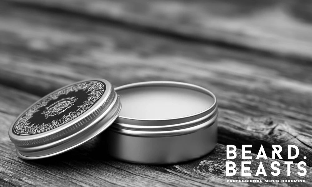 Open tin of beard wax on a rustic wooden surface showing firm texture and high-hold consistency