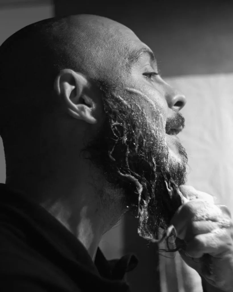 Man washing his beard with too much foam, showing why most men use too much homemade beard wash and wash too often.