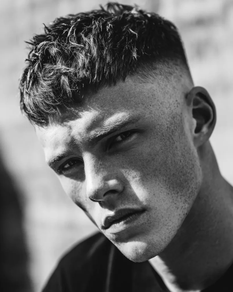 High fade with textured crop haircut for men with short textured top and faded sides

