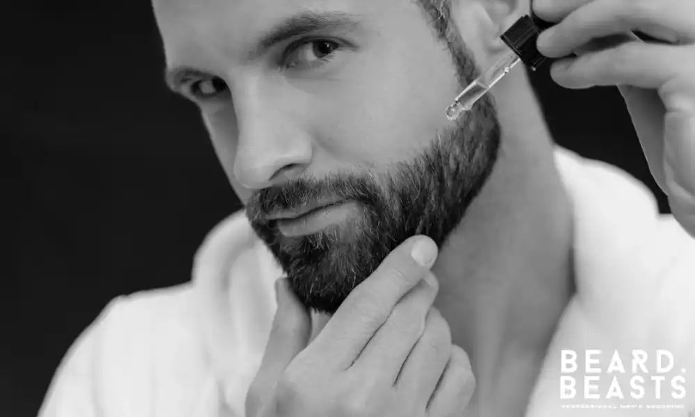 Man applying beard oil to moisturise facial hair and nourish the skin beneath for a healthy, well-groomed beard.
