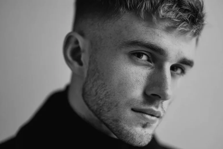 Professional model styling a number 2 beard with a sharp skin fade