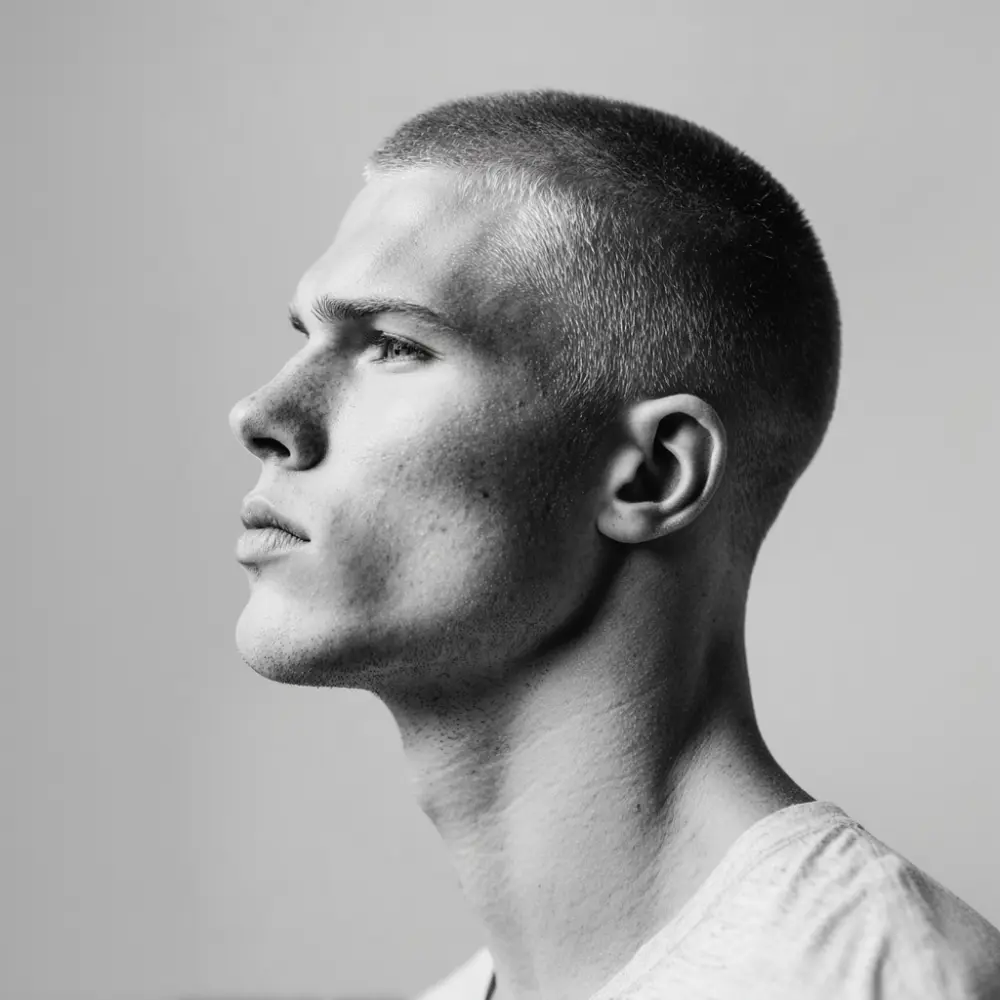 Side profile of a man with a short crew cut and faded sides for a crew cut vs fade hairstyle comparison.