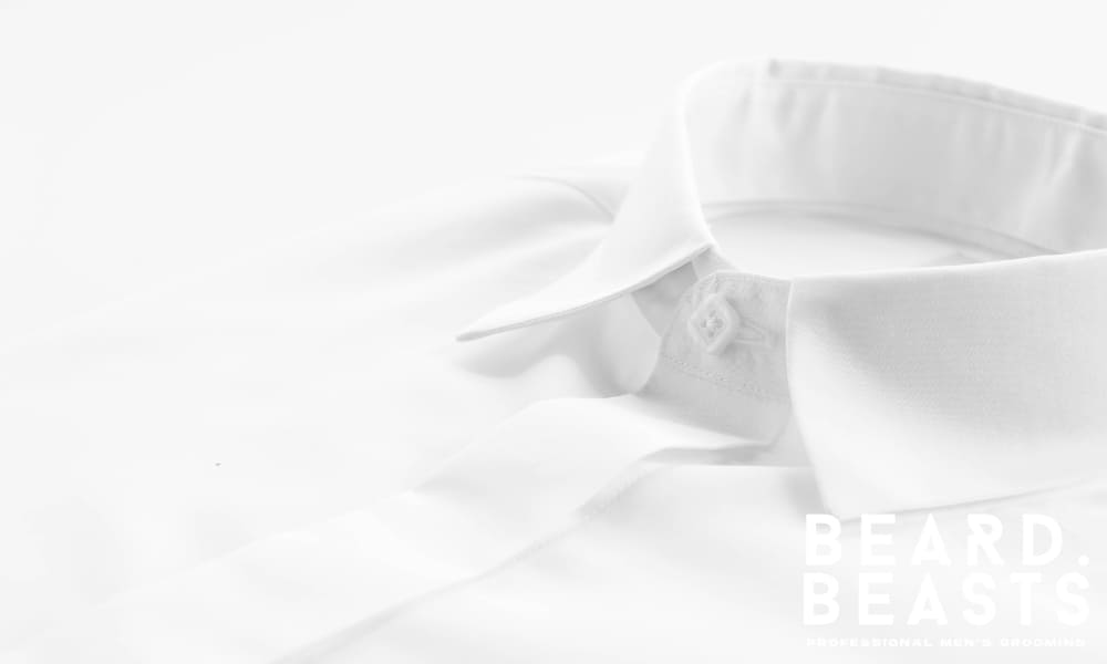 Close-up of a crisp white dress shirt collar showcasing proper structure and clean neckline fit—ideal for explaining how a dress shirt should fit.