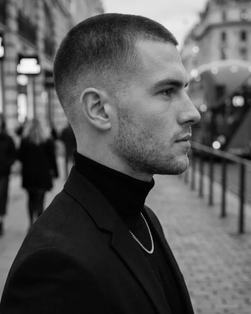 professional buzz cut with fade, side profile in smart casual outfit