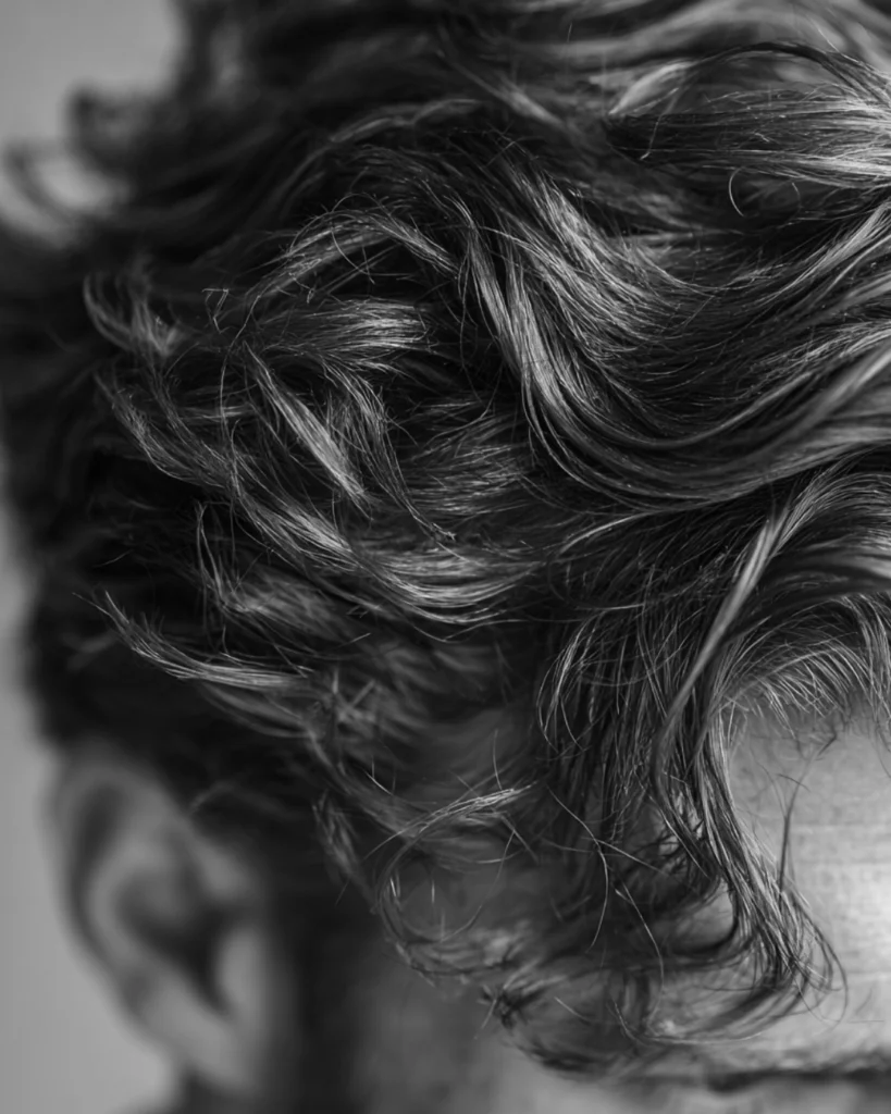Close-up of textured men’s hair, showing how hair type affects whether hair putty or clay is better for grip, movement and styling control.