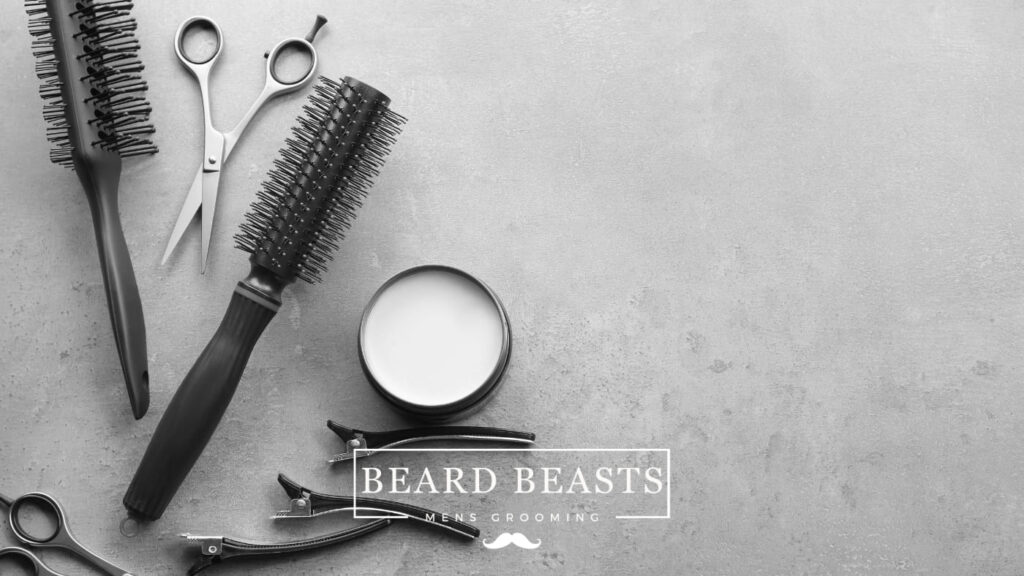 Assortment of men's grooming tools with a jar of styling product, possibly representing hair putty vs clay, for hair styling and maintenance.