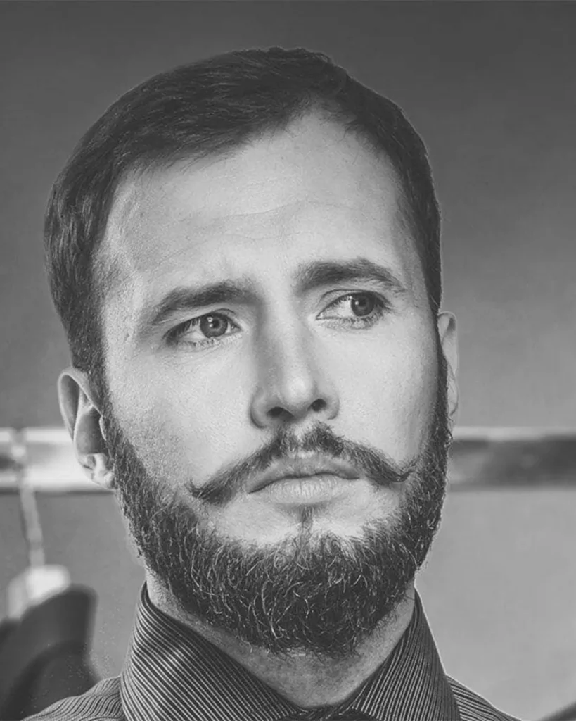 medium Verdi beard style with full cheeks and styled mustache
