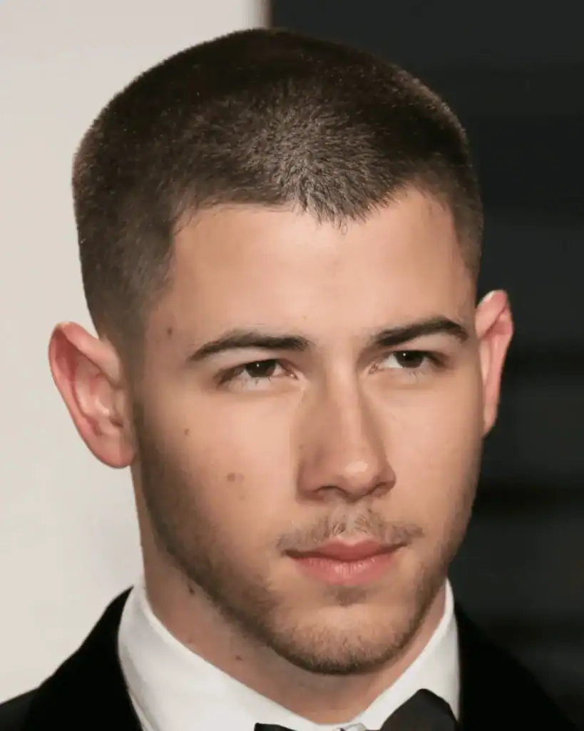 Man with a number 4 buzz cut haircut and short stubble beard showing clean lines and sharp jaw definition