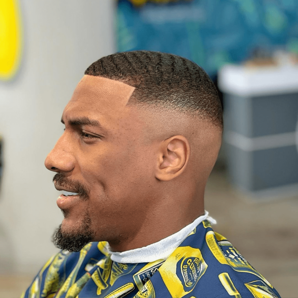 Sharp line-up with clean taper, showcasing defined waves on top and a polished, geometric hairline for a fresh, stylish look
