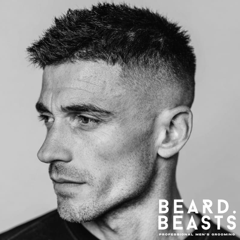 Men's high fade haircut with short, spiky hair on top, creating a sharp contrast and modern, edgy look. Perfect for a bold, clean style with a defined fade.