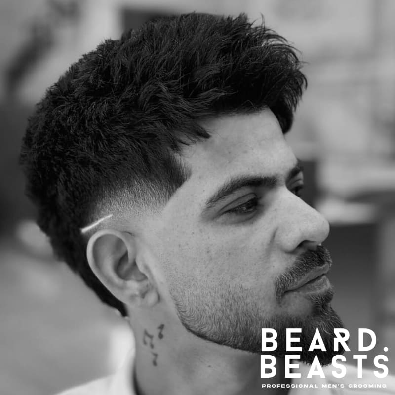 Men's shadow fade haircut featuring a gradual fade that blends smoothly with the hair on top, providing a subtle yet refined look. Ideal for a soft, low-maintenance fade.