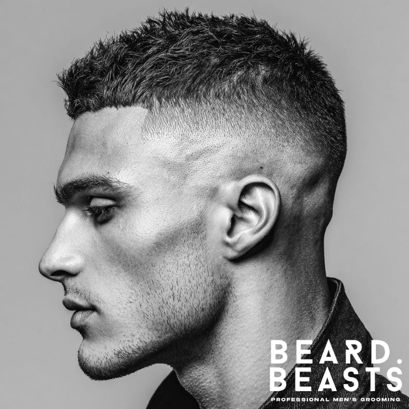 Men's skin fade haircut with a sharp, high contrast fade from the sides to the top, offering a clean, bold, and modern style. Ideal for those looking for a sleek, fresh look.