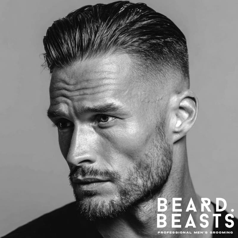 Men's slick back with high fade, featuring a sharp contrast between the slicked-back hair on top and the clean, faded sides. Perfect for a bold, refined look with a modern edge.