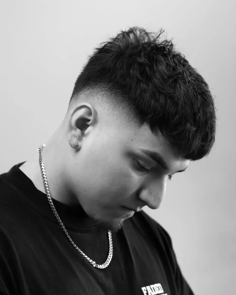 short thick hair with mid skin fade and textured fringe, side profile view