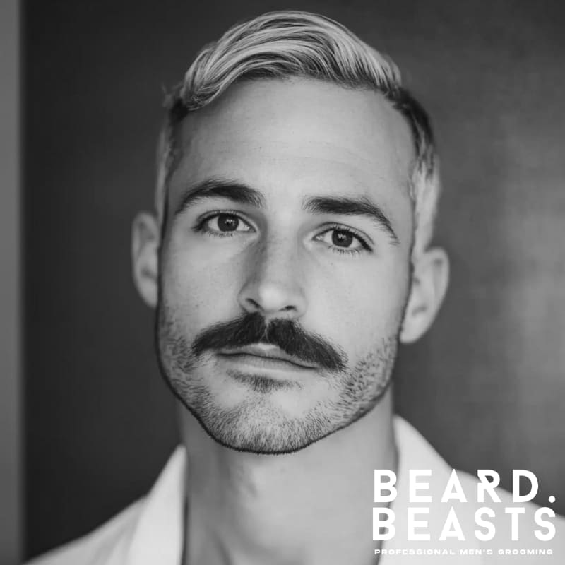 Close-up of a man with a Chevron mustache, one of the most recognizable types of mustaches—thick, full, and covering the upper lip.