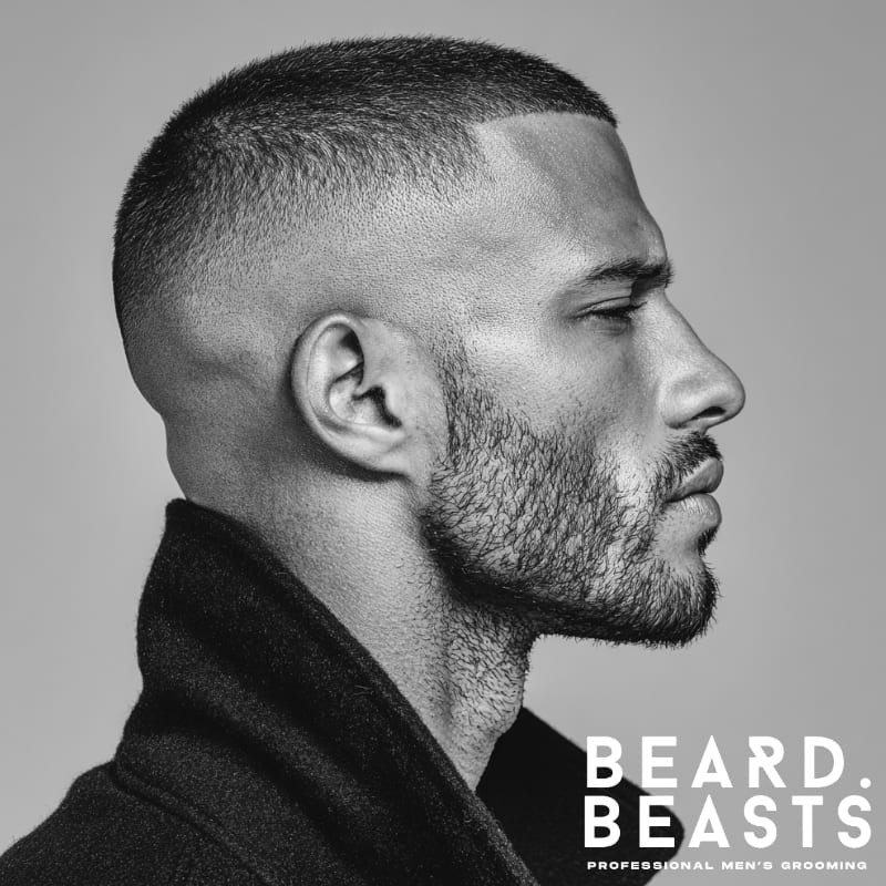 A side profile of a man with a high fade and buzz cut, featuring clean lines and a sharp contrast between the short sides and the slightly longer top.