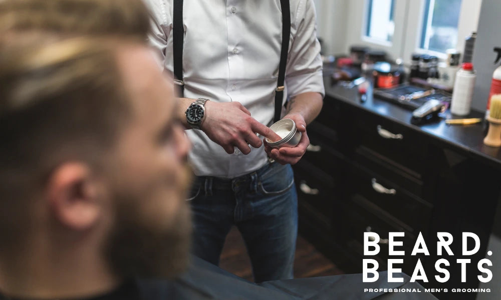 Barber applying styling product for men's haircut, showing how to style a low or mid taper with control and definition.