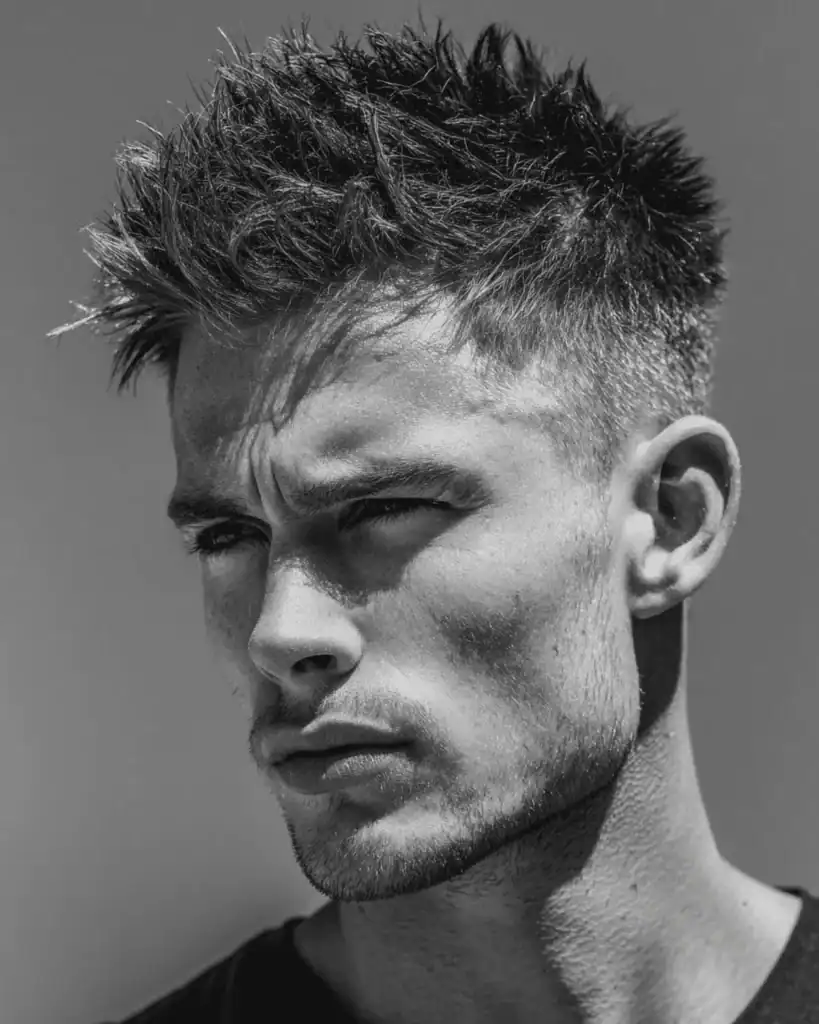 Textured spiky hair with high fade for men, featuring short faded sides and a sharp, spiked top