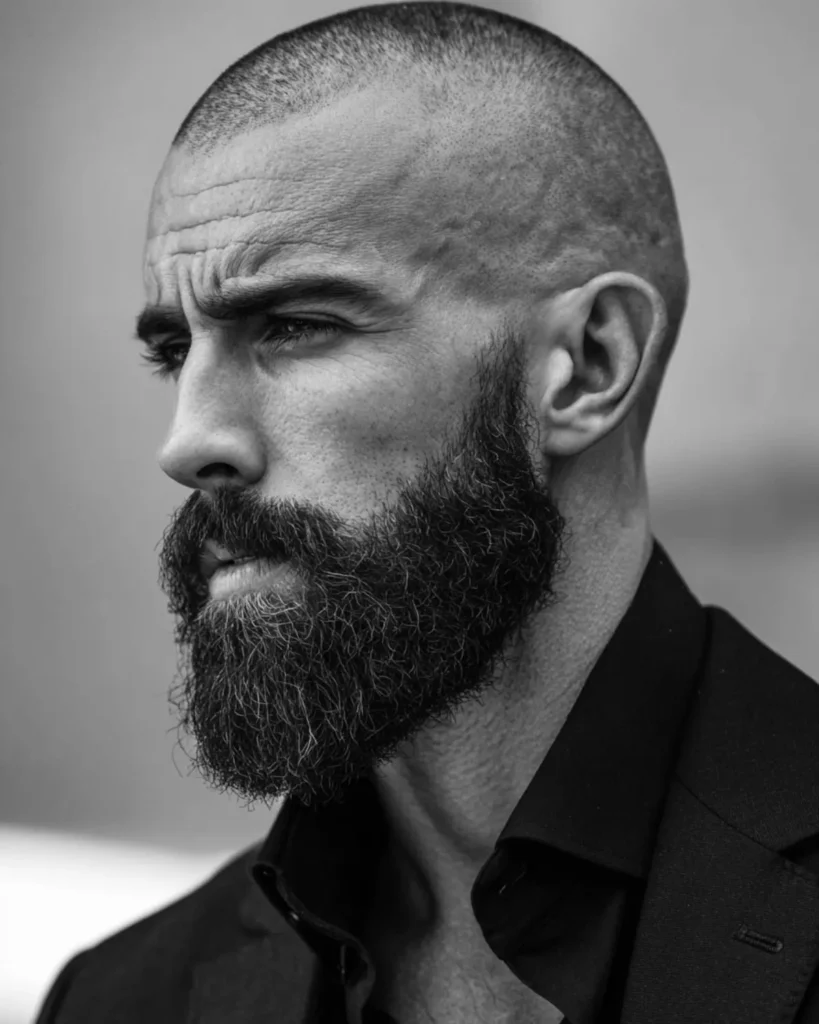 Number 1 buzz cut on a man with a full beard, exposed scalp, and strong facial structure