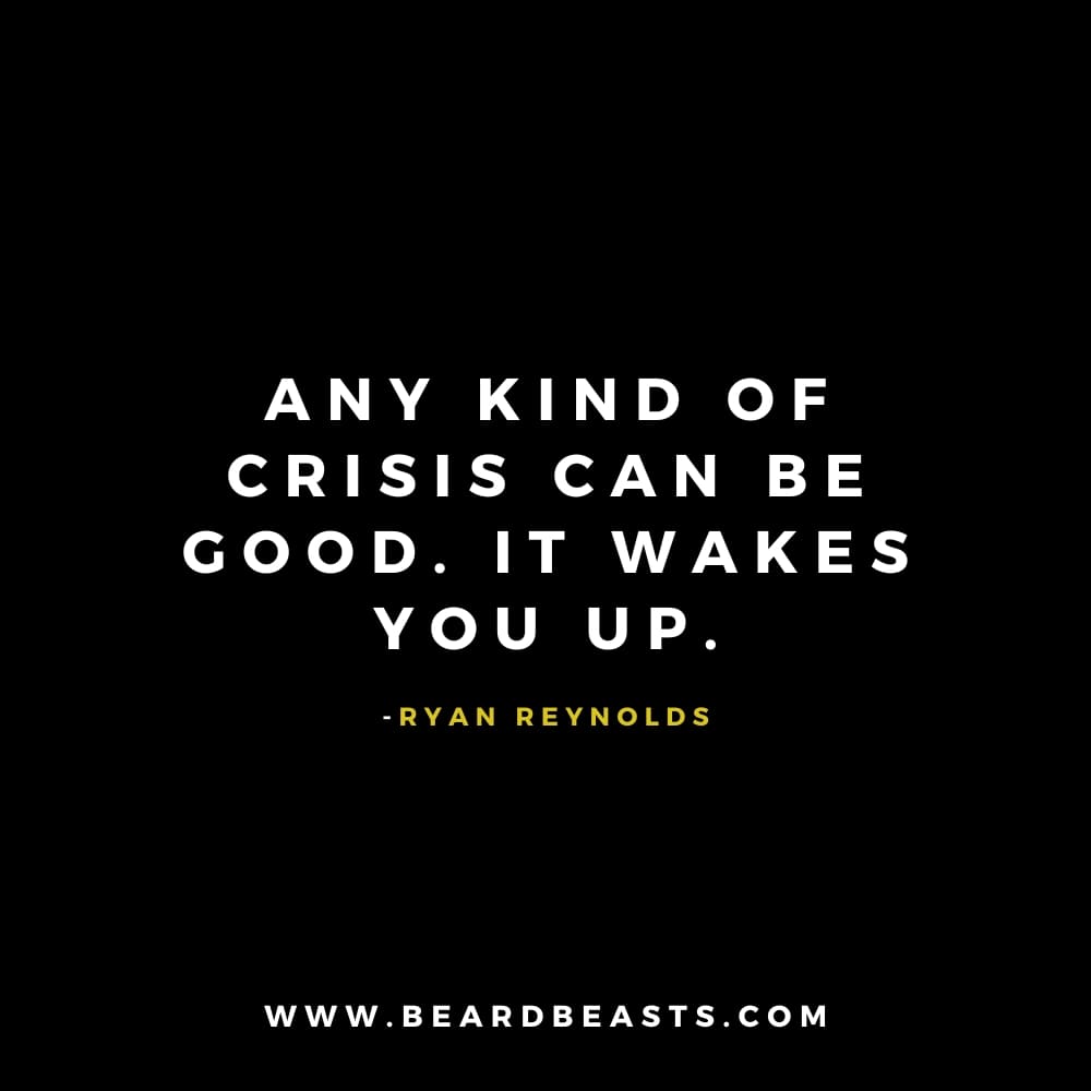 The image features a quote from Ryan Reynolds on a black background. The text, in bold white font, reads: "Any kind of crisis can be good. It wakes you up." Below the quote, Ryan Reynolds' name is written in small yellow font. At the bottom, the website "www.beardbeasts.com" is displayed in white text. This design highlights a thought-provoking man to man quote about resilience, emphasizing the positive impact that crises can have by providing clarity and opportunities for growth.