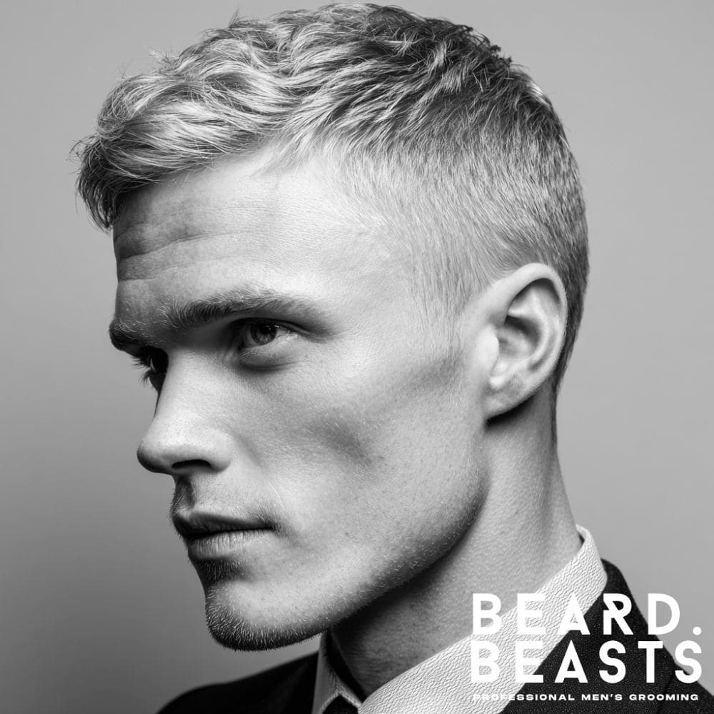 A man with a professional business haircut, featuring a short crew cut with clean short sides, suitable for an office environment.