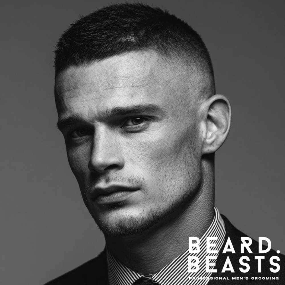 A man with a sharp, high and tight haircut, showcasing a disciplined and professional look suitable for a corporate office.