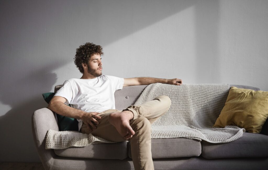 Dad relaxing on the couch, taking a quiet moment for himself, embracing the importance of rest as part of his self-care routine.