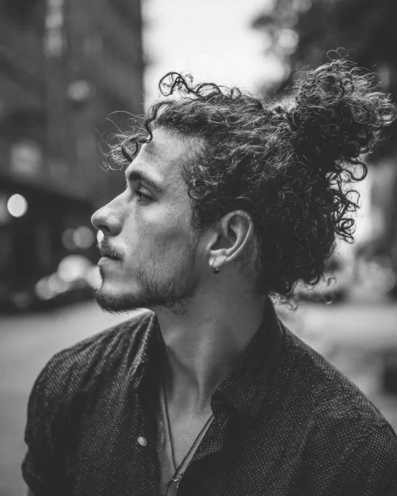 curly man bun hairstyle with natural curl volume, side profile black and white