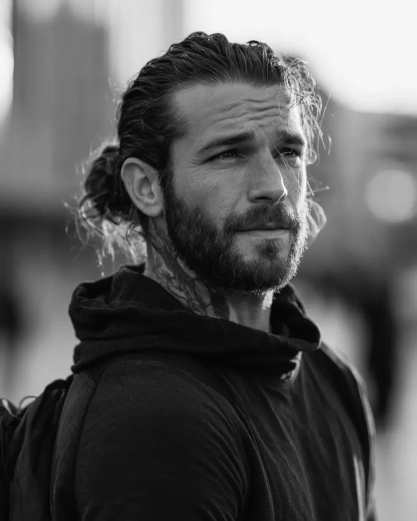low man bun hairstyle tied at the nape, side profile with beard