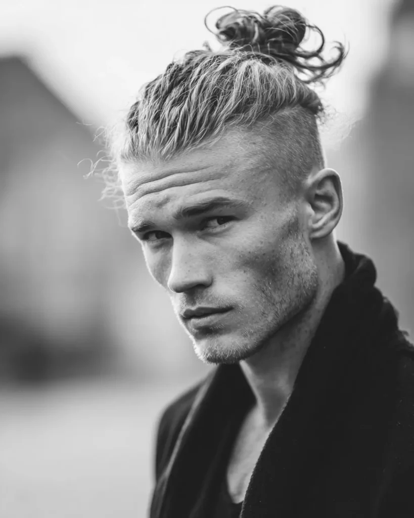 man bun with undercut haircut, faded sides and long textured top, side profile