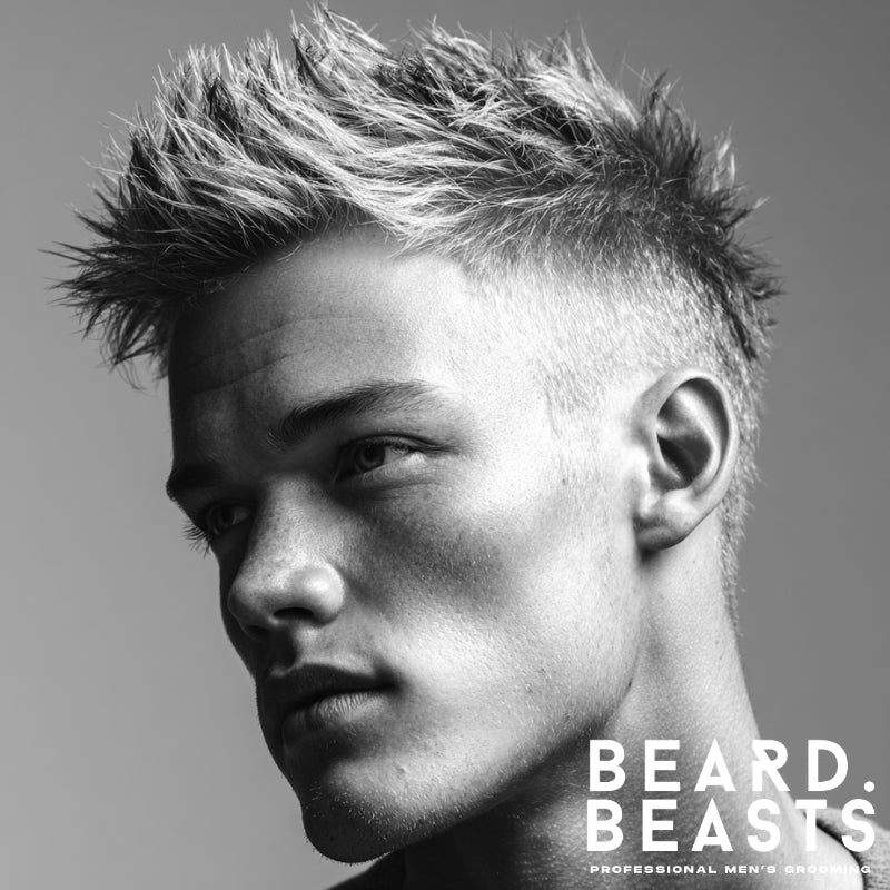 Man with a spiky textured top and faded sides, showcasing a modern short on sides, long on top haircut that adds height, definition, and bold structure.