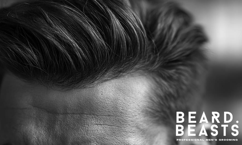 Close-up of a man's well-styled hair, showcasing texture and volume, representing expert tips for men's hair styling and maintenance.