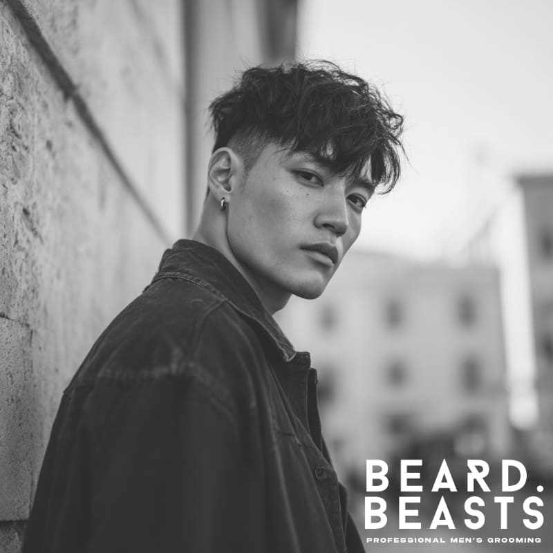 Man showcasing a modern two-block haircut, ideal for men with square face shapes, featuring a textured top and undercut sides.