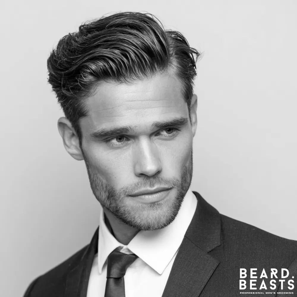 A professional man with a modern textured comb over fade, showcasing a sharp side part and voluminous styling for a stylish business haircut.