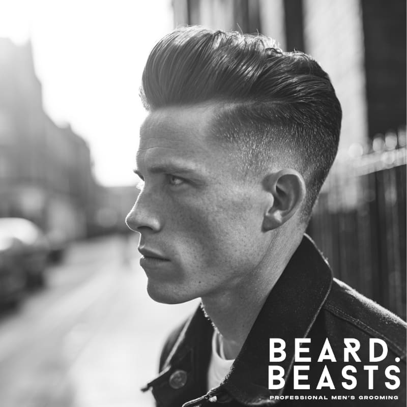 A stylish example of men’s short on sides, long on top haircuts, showcasing a classic pompadour hairstyle with a neat fade. This haircut is perfect for those seeking a sharp, modern look with volume on top and a clean, tapered finish on the sides.